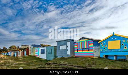 Hopeman village Moray Coast Scotland long row of colourful beach huts overlooking the sandy beach Stock Photo