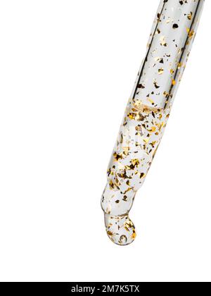 Cosmetic pipette with oily drops with golden splashes close-up on a white background. Stock Photo