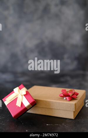 Brown and red gift boxes on dark background Stock Photo