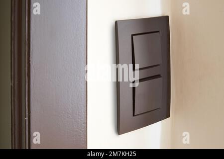 Close-up of a Black light switch on White wall Stock Photo