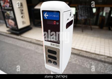 January 6, 2023, Tokyo, Japan: A parking spot with a parking meter in Misakicho. Street parking is rare in Tokyo...Chiyoda City is a special ward located in central Tokyo, Japan. It is known as the political and administrative center of Japan, as it is home to the Japanese government, the Imperial Palace, and the National Diet (Japan's parliament). Chiyoda City is also home to many embassies, business headquarters and cultural institutions, making it a hub of international activity. It has a population of about 60,000 people and is known for its parks, museums, and shrines. Some popular attrac Stock Photo