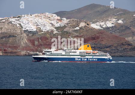 A Blue Star Ferries vessel passes below Oia Santorini Greece Stock Photo