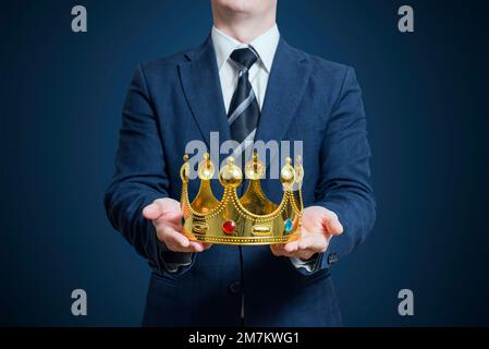 Businessman holding in the hands of the crown Stock Photo