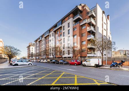 Facades of residential buildings on a sunny winter day with zebra crossings and no-stop zone with deciduous trees on a sunny winter day Stock Photo