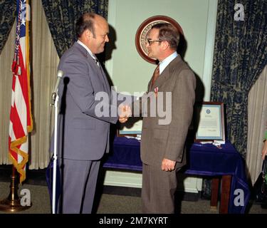 Secretary of Defense Melvin R. Laird, left, congratulates J. Fred Buzhardt Jr., department of defense general counsel, after presenting him with the Department of Defense Distinguished Public Service Medal during a ceremony at the Pentagon. Buzhardt has served in his position since August 20, 1970. Base: Arlington State: Virginia (VA) Country: United States Of America (USA) Stock Photo