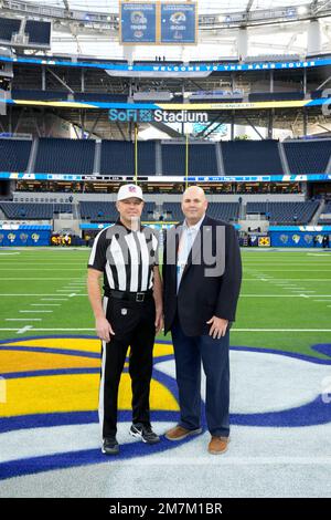 Referee Brad Rogers, left stands with replay official Durwood Manley before  an NFL football game between the Los Angeles Rams and the Las Vegas Raiders,  Thursday, Dec. 8, 2022, in Inglewood, Calif. (