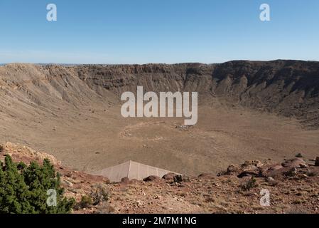 An aerial view of Meteor Crater deserted land on a sunny day Stock Photo