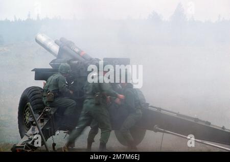 An M114 155 mm howitzer in operation during a training exercise. Country: Unknown Stock Photo