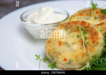 Cheese pancake with sour cream, spinach and microgreens on white plate. Healthy meal concept. Vegetarian food concept. Food background. Stock Photo