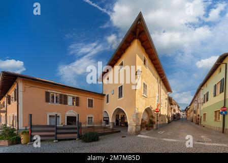Peveragno, Cuneo, Italy - January 09; 2023: Via Guglielmo Marconi with ancient palaces with arcades of medieval origin, historical centre Stock Photo