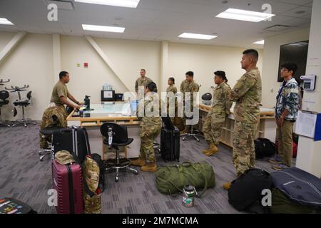 Members of the Hawaii Air National Guard (HIANG) Headquarters Detachment 1 (Det 1) receive their preflight briefing form the Hawaii Army National Guard CH-47 air crew before a flight from Oahu to Kauai for their first super drill of 2022, May 10, 2022, Kalaeloa, Hawaii. The HIANG Det 1 which is slated to become a space electromagnetic warfare squadron (EWS) is holding a six-day super drill in May 2022 to increase the impact of their training. Stock Photo