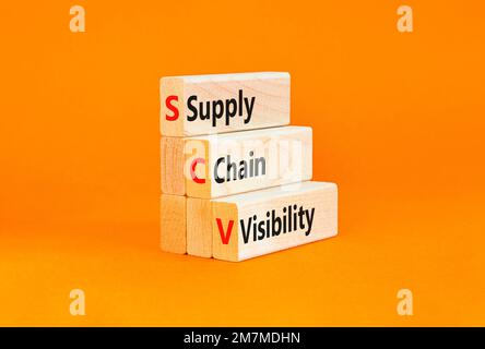 SCV supply chain visibility symbol. Concept words SCV supply chain visibility on wooden blocks on a beautiful orange table orange background. Business Stock Photo