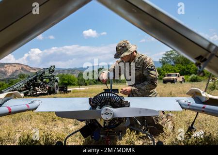 Spc. Ryan Lemon, an Unmanned Aircraft Systems Repairer assigned to the 7-17th Air Cavalry Squadron, 1st Air Cavalry Brigade readies a RQ-7B V2 Shadow during Exercise Swift Response on May 11, 2022 at Krivolak Training Area, North Macedonia. Exercise Swift Response 2022 is an annual multinational training exercise, which takes place in Eastern Europe, the Arctic High North, Baltics, and Balkans from May 2-20, 2022. It aims to present combat credible Army forces in Europe and Africa and enhance readiness by building airborne interoperability with Allies and Partners and the integration of joint Stock Photo