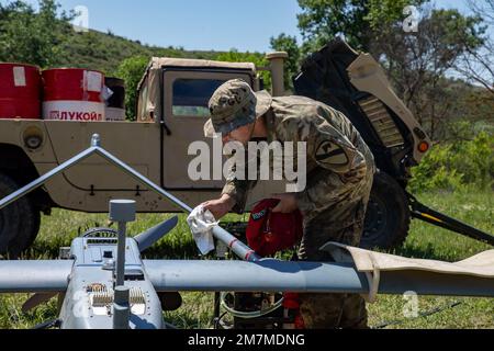 Spc. Ryan Lemon, an Unmanned Aircraft Systems Repairer assigned to the 7-17th Air Cavalry Squadron, 1st Air Cavalry Brigade readies a RQ-7B V2 Shadow during Exercise Swift Response on May 11, 2022 at Krivolak Training Area, North Macedonia. Exercise Swift Response 2022 is an annual multinational training exercise, which takes place in Eastern Europe, the Arctic High North, Baltics, and Balkans from May 2-20, 2022. It aims to present combat credible Army forces in Europe and Africa and enhance readiness by building airborne interoperability with Allies and Partners and the integration of joint Stock Photo