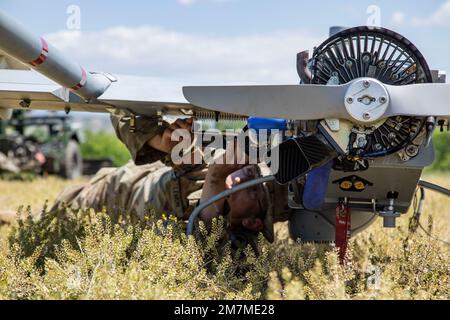 Spc. Ryan Lemon, an Unmanned Aircraft Systems Repairer assigned to the 7-17th Air Cavalry Squadron, 1st Air Cavalry Brigade readies a RQ-7B V2 Shadow during Exercise Swift Response on May 11, 2022 at Krivolak Training Area, North Macedonia. Exercise Swift Response 2022 is an annual multinational training exercise, which takes place in Eastern Europe, the Arctic High North, Baltics, and Balkans from May 2-20, 2022. It aims to present combat credible Army forces in Europe and Africa and enhance readiness by building airborne interoperability with Allies and Partners and the integration of joint Stock Photo