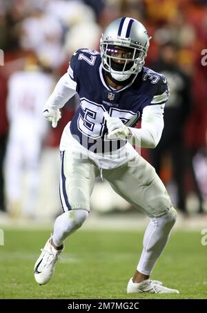 Dallas Cowboys wide receiver CeeDee Lamb (88) is tackled by San Francisco  49ers cornerback Jimmie Ward (1) during the first half of an NFL divisional  playoff football game in Santa Clara, Calif.