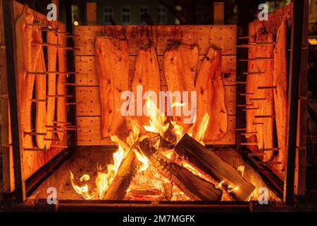 Flame salmon on the wood fire Stock Photo