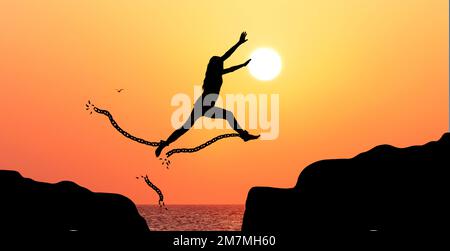 Silhouette of a woman jumping and bursting shackles Stock Photo