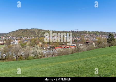 Europe, Germany, Southern Germany, Baden-Wuerttemberg, Schönbuch region, view over the meadow to the western part of Tübingen with a passing suburban train Stock Photo