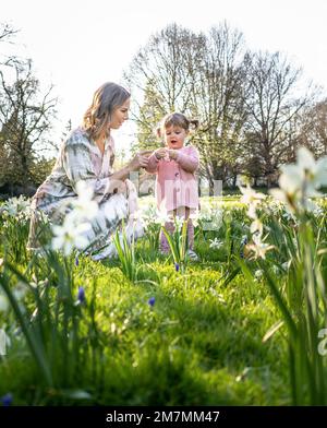 Europe, Germany, Baden-Wuerttemberg, Stuttgart, Hohenheim Castle, mother playing with little daughter in a flower meadow in the botanical garden of the University of Hohenheim Stock Photo