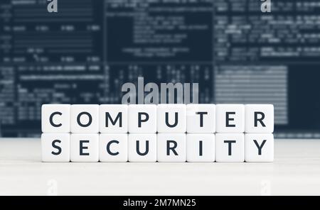 Computer security concept. Text on cube blocks and blurry background of computer screen with data Stock Photo