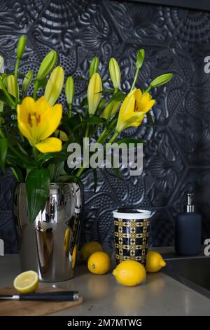 Still life with bouquet of yellow flowers and lemons Stock Photo