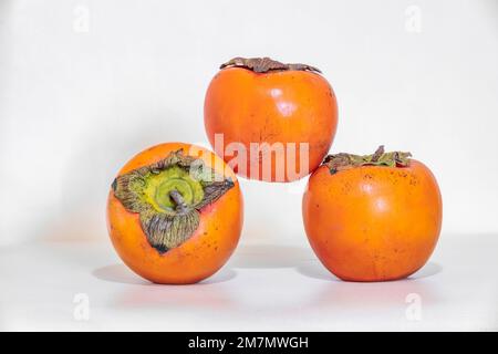 Diospyros kaki, Persimmon, seasonal fruit isolated on white background Stock Photo