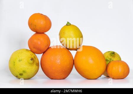 group of seasonal fruits composed of oranges, lemons and tangerines on a white background Stock Photo