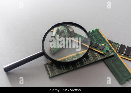 Green computer chip with a magnifying glass close-up. Stock Photo