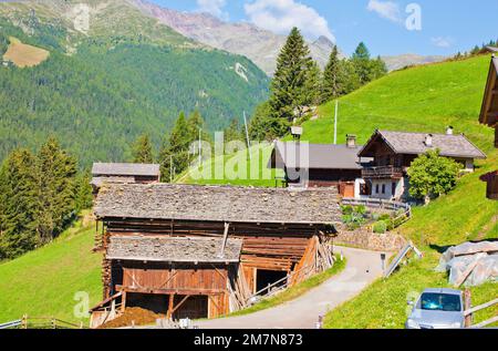 Group of farms on a steep slope in the South Tyrolean Ulten Valley Stock Photo