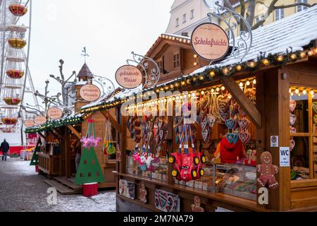 Stalls at a Christmas market with Christmas food and sweets on the day in December. Stock Photo