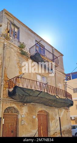 Abandoned dilapidated house against sunny sky in Menfi, Sicily Stock Photo