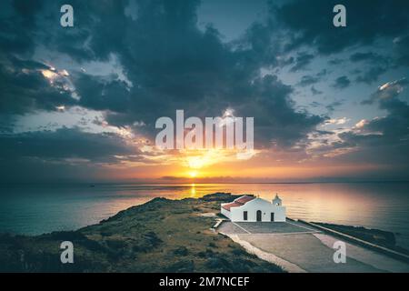 View of a sunrise over the sea, The Chapel of Agios Nikolaos on a rock in the backlight, Zakyntos, Ionian Islands, Greece Stock Photo