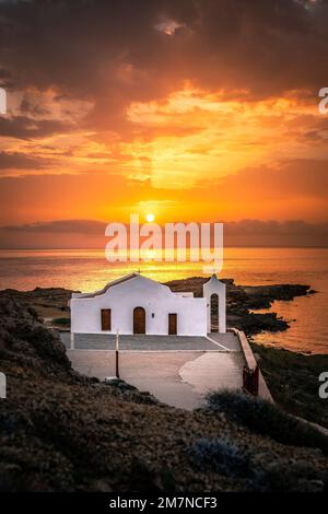 View of a sunrise over the sea, The Chapel of Agios Nikolaos on a rock in the backlight, Zakyntos, Ionian Islands, Greece Stock Photo