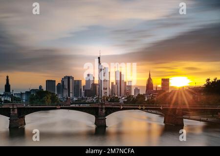 Long exposure with view over the Main River, the Ignatz Bubis Bridge and the skyline in the sunset. Backlight shot of Frankfurt am Main, Hesse, Germany Stock Photo