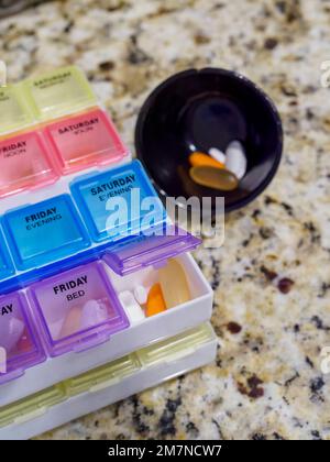 Prescription pill box for medication or vitamins or supplements for daily medication doses. Stock Photo