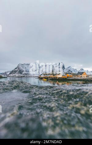 Fishing village in Reine with yellow houses, Moskenesoya, Lofoten, Nordland, Norway Stock Photo