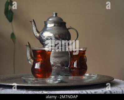 Two cups of turkish tea. Turkish black tea copper tea kettle. Stock Photo