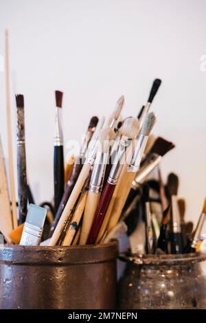 Close-up of a container with different brushes in a studio Stock Photo