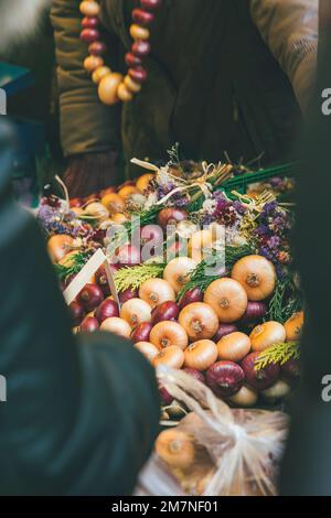 People at traditional Zibelemärit, onion market in Bern, Switzerland, edible onions (Allium cepa), close-up, onion plait Stock Photo