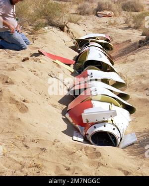 A close-up view of a damaged AGM-109 Tomahawk air-launched cruise missile on the ground after impact. Country: Unknown Stock Photo