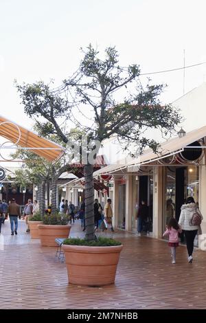 Faro, Portugal - December 22, 2019: Row of trees with Christmas lights at Forum Algarve, a shopping center in Portugal on a warm winter day. Stock Photo