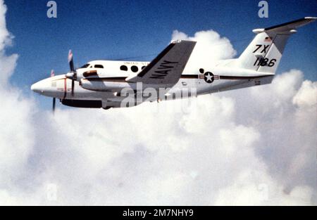 An air-to-air left side view of a UC-12B transport aircraft. The UC-12B was recently placed into service with the Navy. Base: Naval Air Station, New Orleans State: Louisiana (LA) Country: United States Of America (USA) Stock Photo