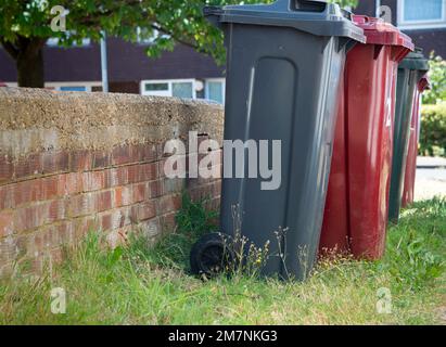 Line of rubbish, recycling or wheelie bins outside a domestic property in Reading, Berkshire, England, UK Stock Photo