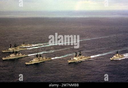 An aerial port bow view of six ships in the USS INDEPENDENCE (CV-62) battle group as they head home from deployment in the Mediterranean Sea. The ships are, clockwise from the right , USS MCCANDLESS (FF-1084), USS PETERSON (DD-969), USS FARRAGUT (DDG-37), USS MAHAN (DDG-42), USS CARON (DD-970) and USS GARCIA (FF-1040). Country: Atlantic Ocean (AOC) Stock Photo