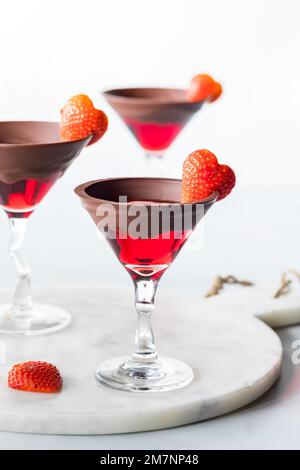 Beautiful chocolate rimmed Valentine's Day cocktails with strawberry garnish. Stock Photo