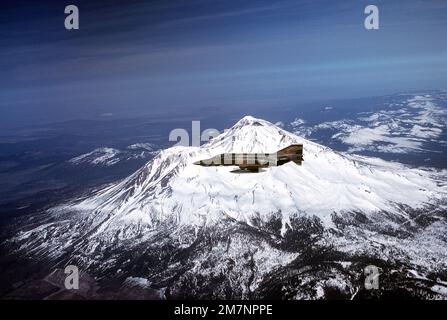 A left side view of an RF-4C Phantom II aircraft flying past the snow-capped mountains. The aircraft is from the 152nd Tactical Reconnaissance Group, Nevada Air National Guard. Base: Sierra Mountains State: Nevada (NV) Country: United States Of America (USA) Stock Photo