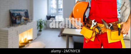 Cropped shot of young repairman wearing a tool belt with various tools Stock Photo