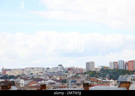 LVIV, UKRAINE - SEPTEMBER 11, 2022 Panorama view of the historical old city in Lviv, Ukraine. Many old buildings with metal roofs and cathedral domes in beginning of autumn day Stock Photo