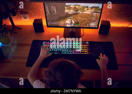 Image of immersed teenage gamer boy playing video games on computer in ...